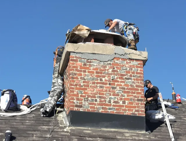 Dartmouth Chimney Sweep installing a custom chimney crown in Dartmouth, MA